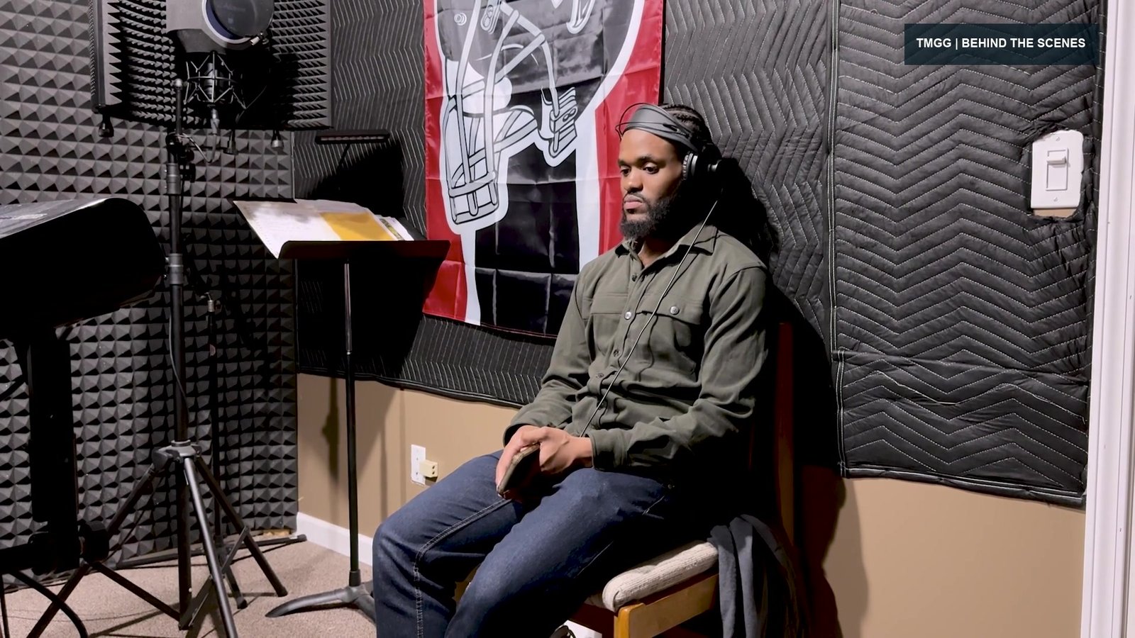 RB wearing headphones at the microphone during a recording session
